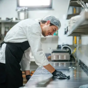 the-restaurant-chef-is-wiping-down-the-kitchen-counter the-restaurant-chef-is-wiping-down-the-kitchen-counter